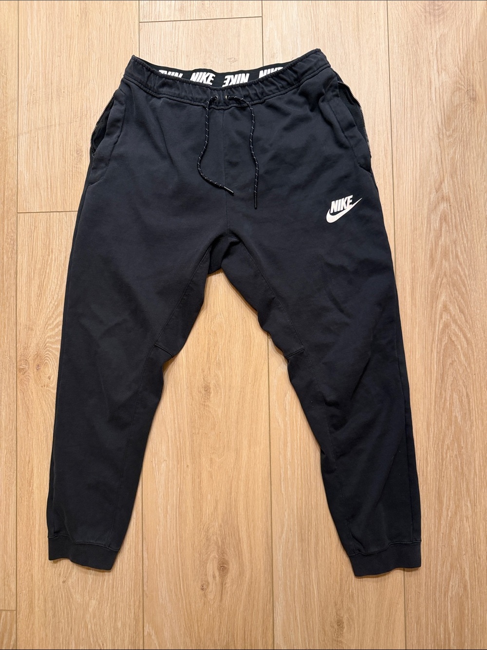 Nike Black Jogger Sweatpants with White Logo and side zippered pockets